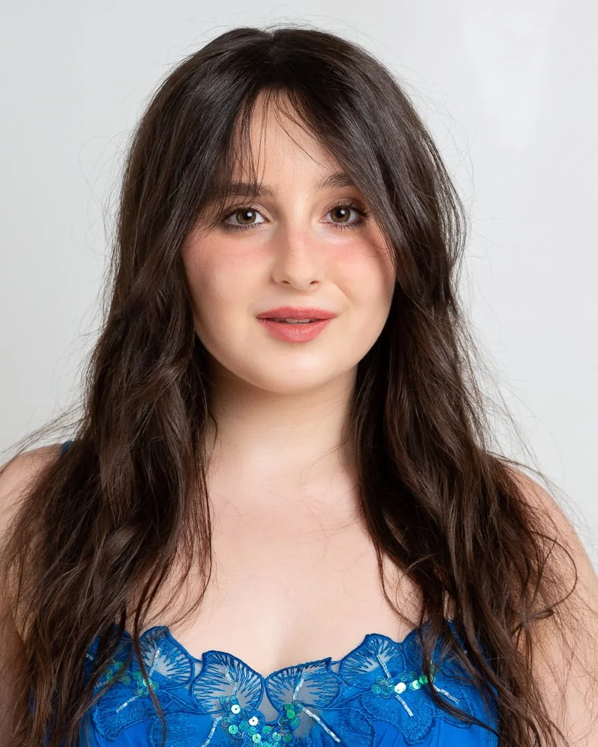 A teen girl poses for a headshot up