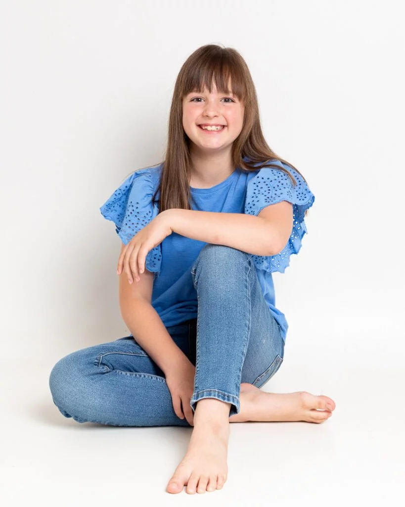 Child Model Actor Head Shots Updates West Sussex a girl poses for a photo shoot in blue jeans and a blue tshirt