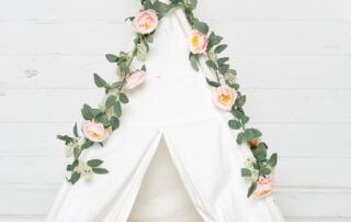 small white tent styled with pink flowers studio prop