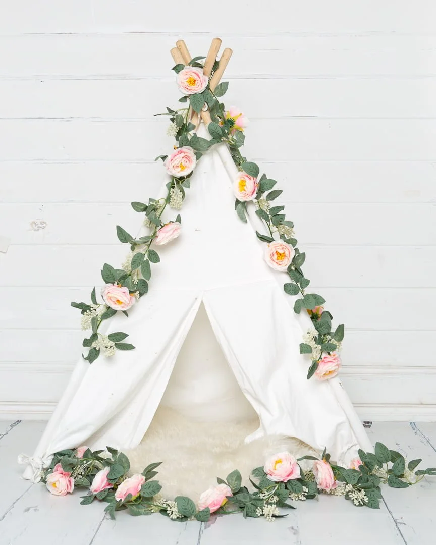 small white tent styled with pink flowers studio prop