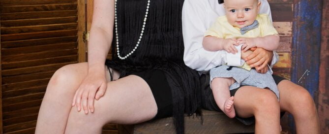 A family of four children poses dressed in 1920s outfits