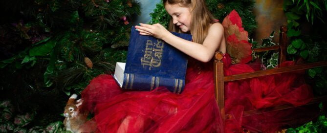 a fairy dressed in red peeks inside my magical fairy tale book