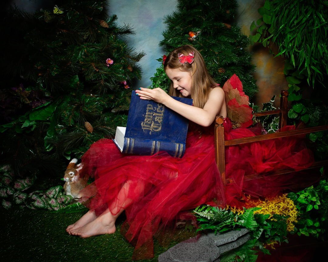 a fairy dressed in red peeks inside my magical fairy tale book