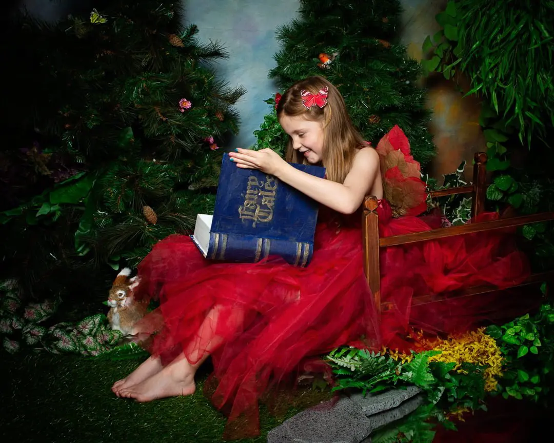 a fairy dressed in red peeks inside my magical fairy tale book