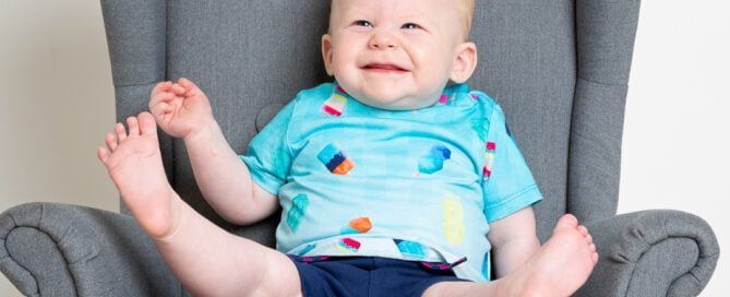 a little boy is so excited that his legs are flying up in the air