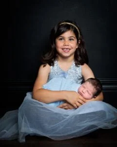Newborn Photography East Grinstead West Sussex sisters in matching blue at a newborn photo shoot
