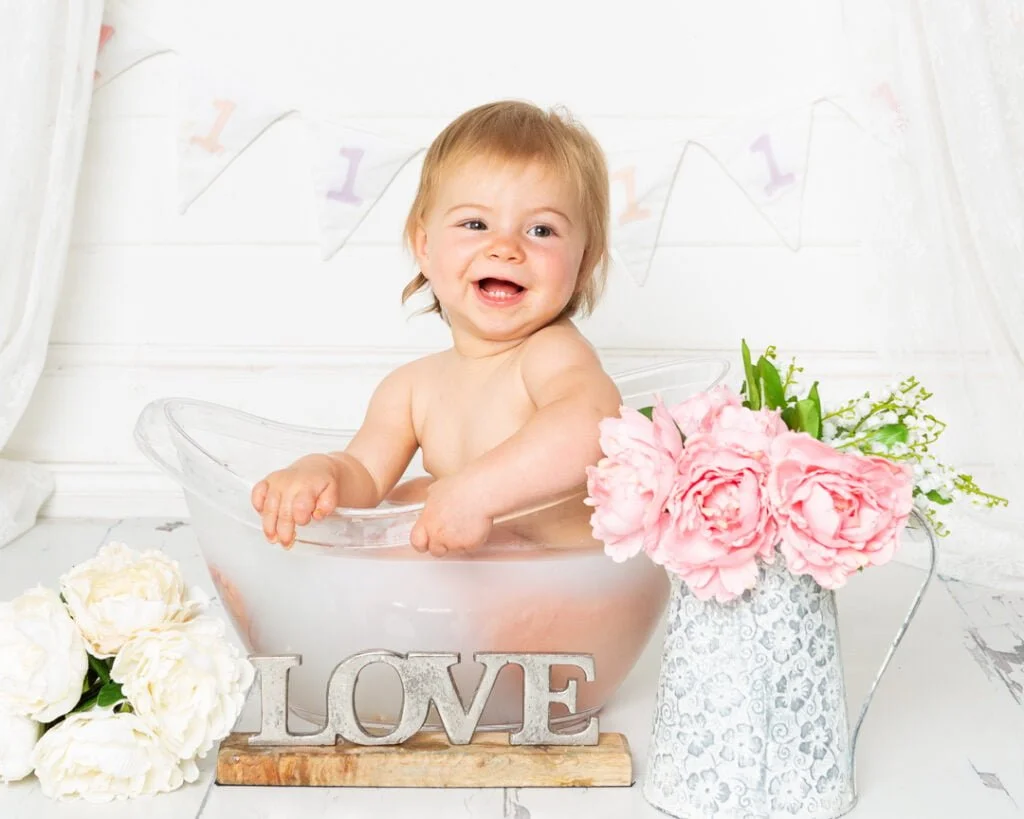 a floral set up for a milk bath for a little girl's first birthday photo shoot
