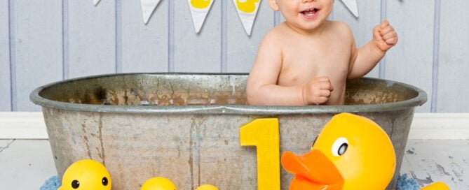a duck themed tub splash photo shoot with a blue backdrop
