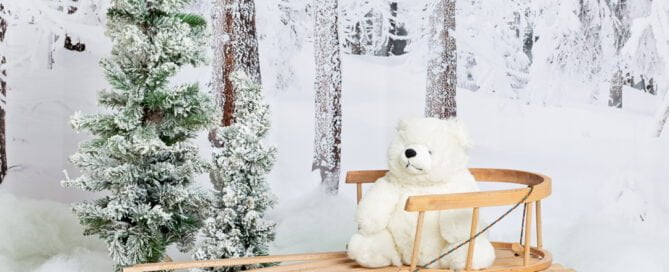 a wooden sledge in a christmas snowy themed photo shoot set