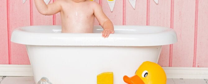 a duck themed tub splash photo shoot with a pink backdrop