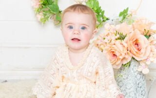 a little girl in a boho style outfit poses at her photo shoot at my studio in East Grinstead