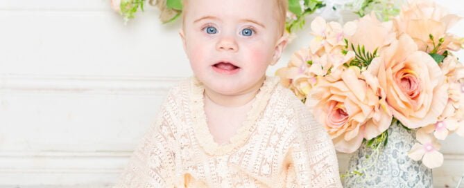 a little girl in a boho style outfit poses at her photo shoot at my studio in East Grinstead