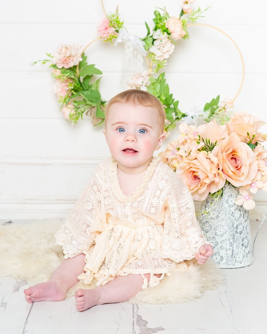 a little girl in a boho style outfit poses at her photo shoot at my studio in East Grinstead