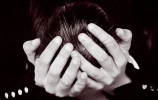 a mother's hands hold a newborn