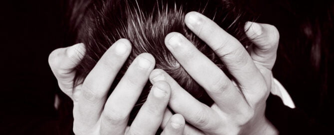 a mother's hands hold a newborn