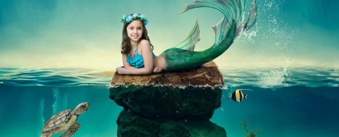 a little girl lies on a rock in a digital mermaid photo shoot