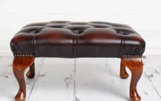 Brown leather footstool studio prop