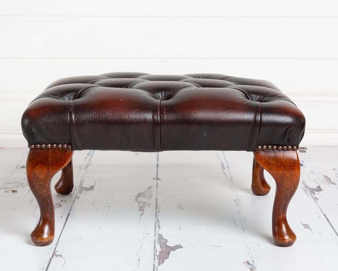 Brown leather footstool studio prop