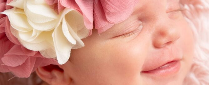 a newborn with a big smile on her face