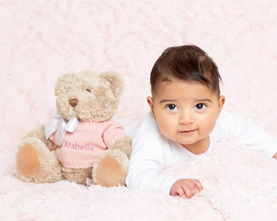 a baby and a pink personalised teddy bear