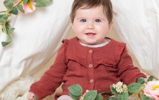 a little girl ina flower covered tent