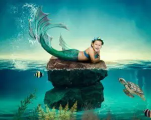 a little girl with short dark hair in a digital mermaid photo