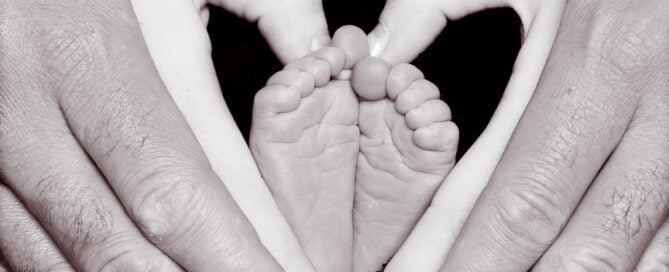 newborn feet framed in their parents hands