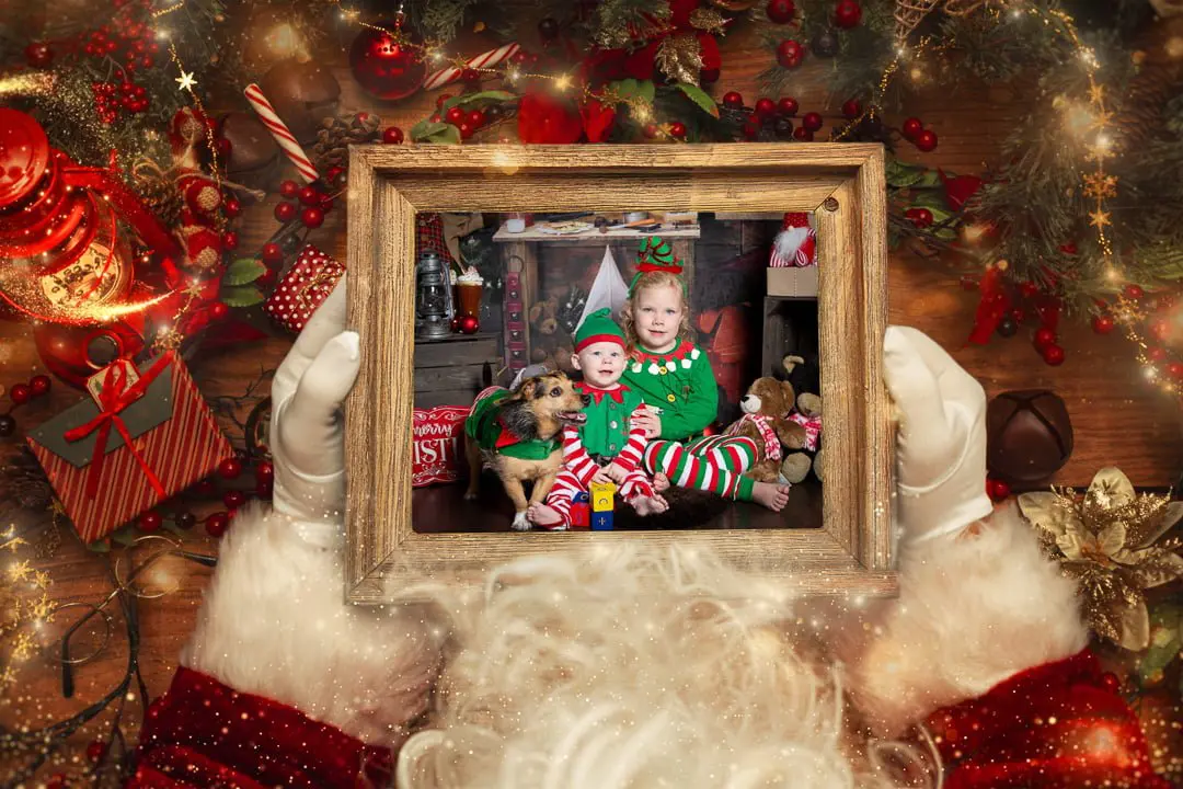 a digital image of a family in a picture frame being held by santa