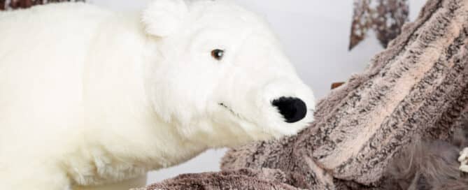 a friendly looking giant polar bear toy smiles for the camera