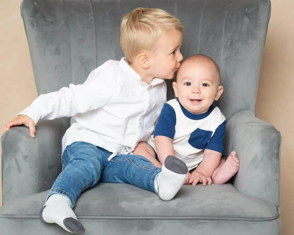 Family Portrait Photo Shoot East Grinstead West Sussex a big brother giving a kiss to his little brother