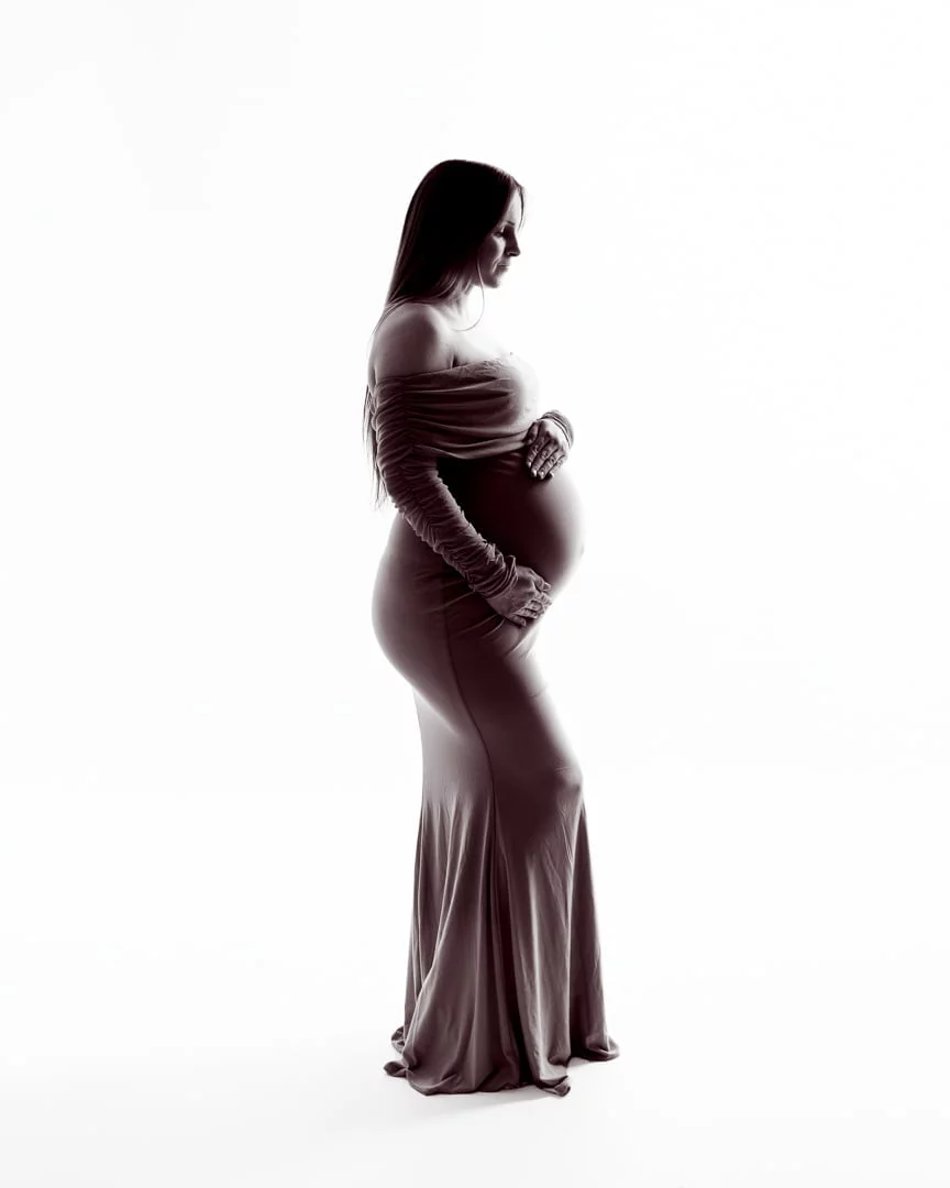 a black and white silhouette of a pregnant woman in a fitted dress
