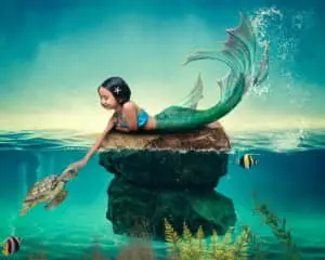 a little girl with dark hair at a mermaid photo shoot