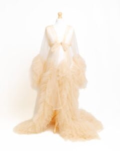 a tulle cream maternity dress on a mannequin