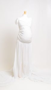 a white sheer long trained maternity dress on a mannequin