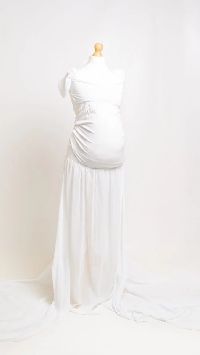 a white sheer long trained maternity dress on a mannequin