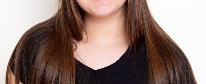 a girl poses against a white background