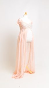 a peach maternity dress on a mannequin