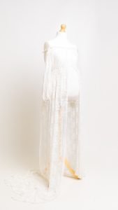 a white lace maternity dress on a mannequin