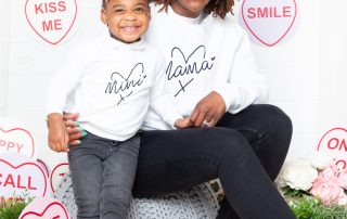 A mother and daughter pose in a love heart themed mother's Day set