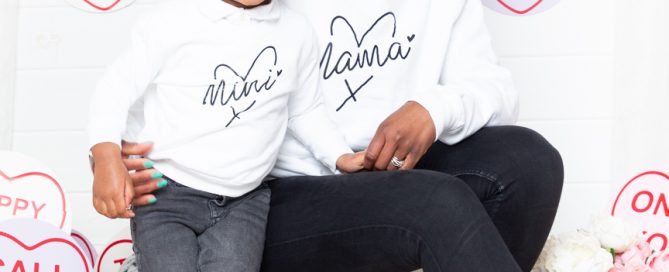 A mother and daughter pose in a love heart themed mother's Day set