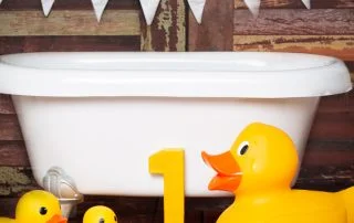 a white tub with yellow duck props
