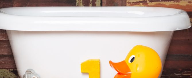 a white tub with yellow duck props
