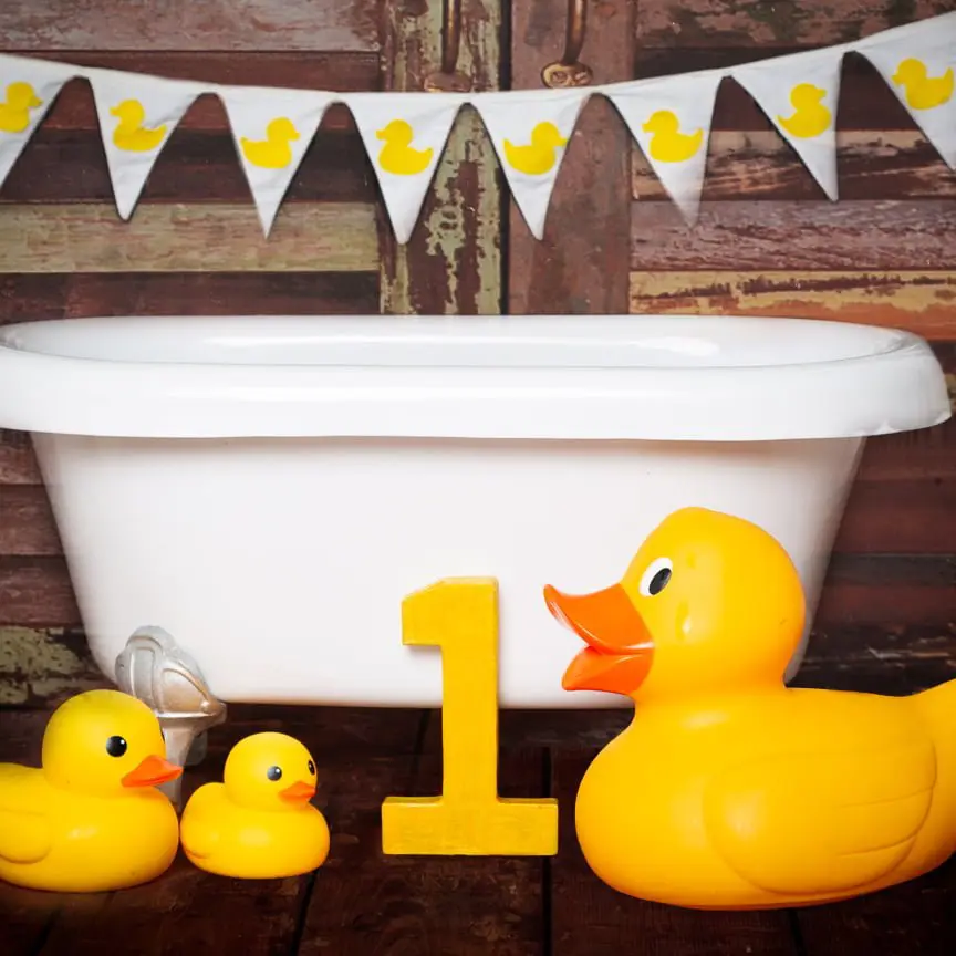 a white tub with yellow duck props