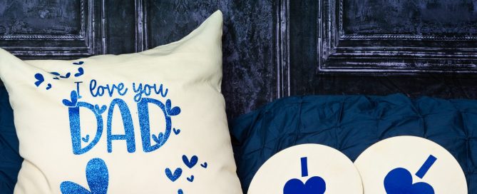 a navy bed and backdrop with a large cushion that says I love Dad