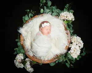 a sleeping newborn in my wooden bowl prop with white hydrangeas