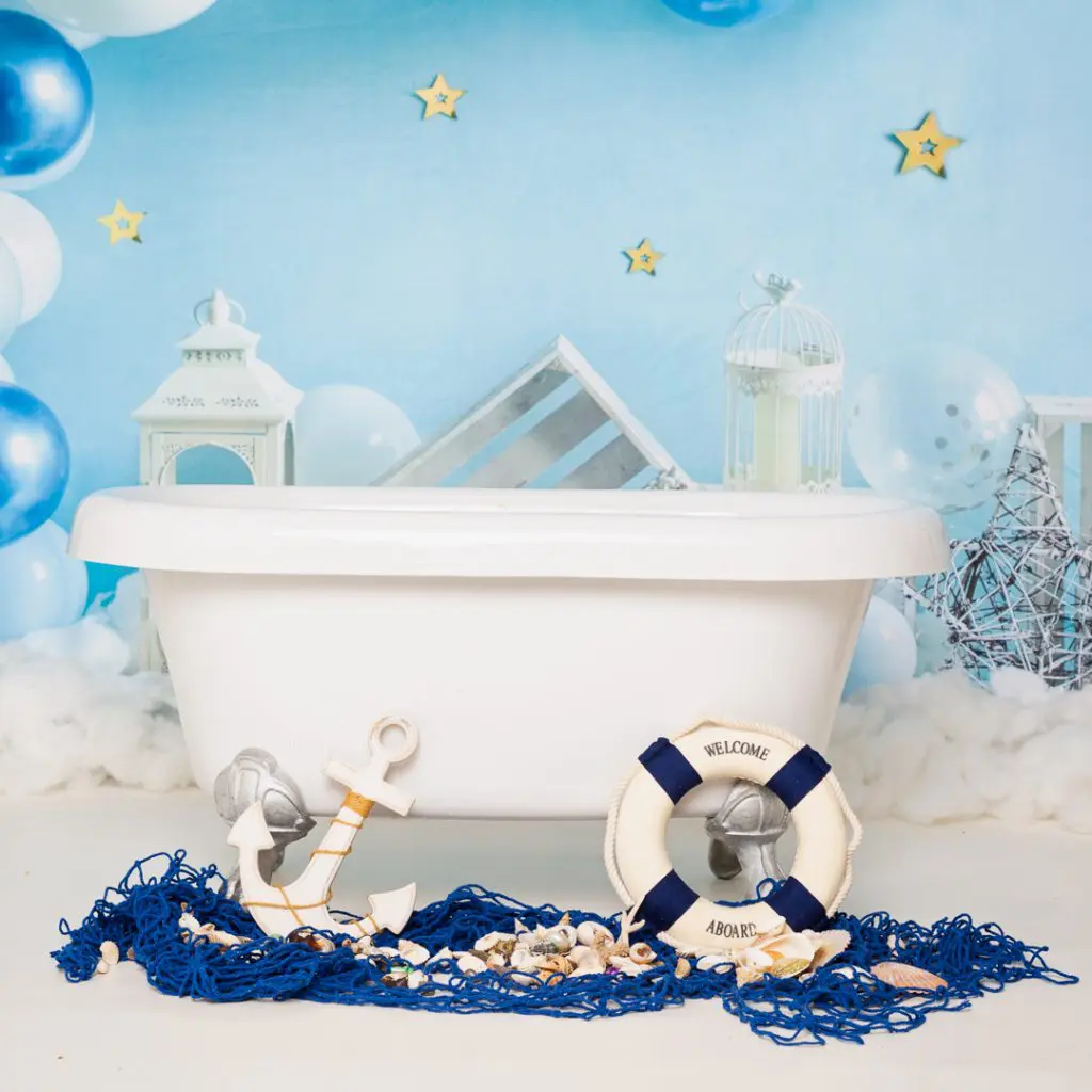 A miniature roll top bath surrounded with nautical tub splash accessories