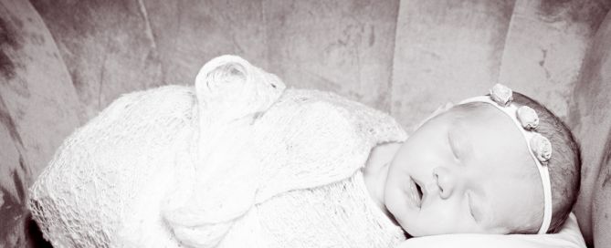 a newborn with her name spelled out in letter blocks
