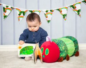 Baby Photography West Sussex a baby reading the very hungry caterpillar