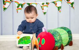 a baby reading the very hungry caterpillar