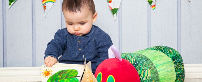 a baby reading the very hungry caterpillar